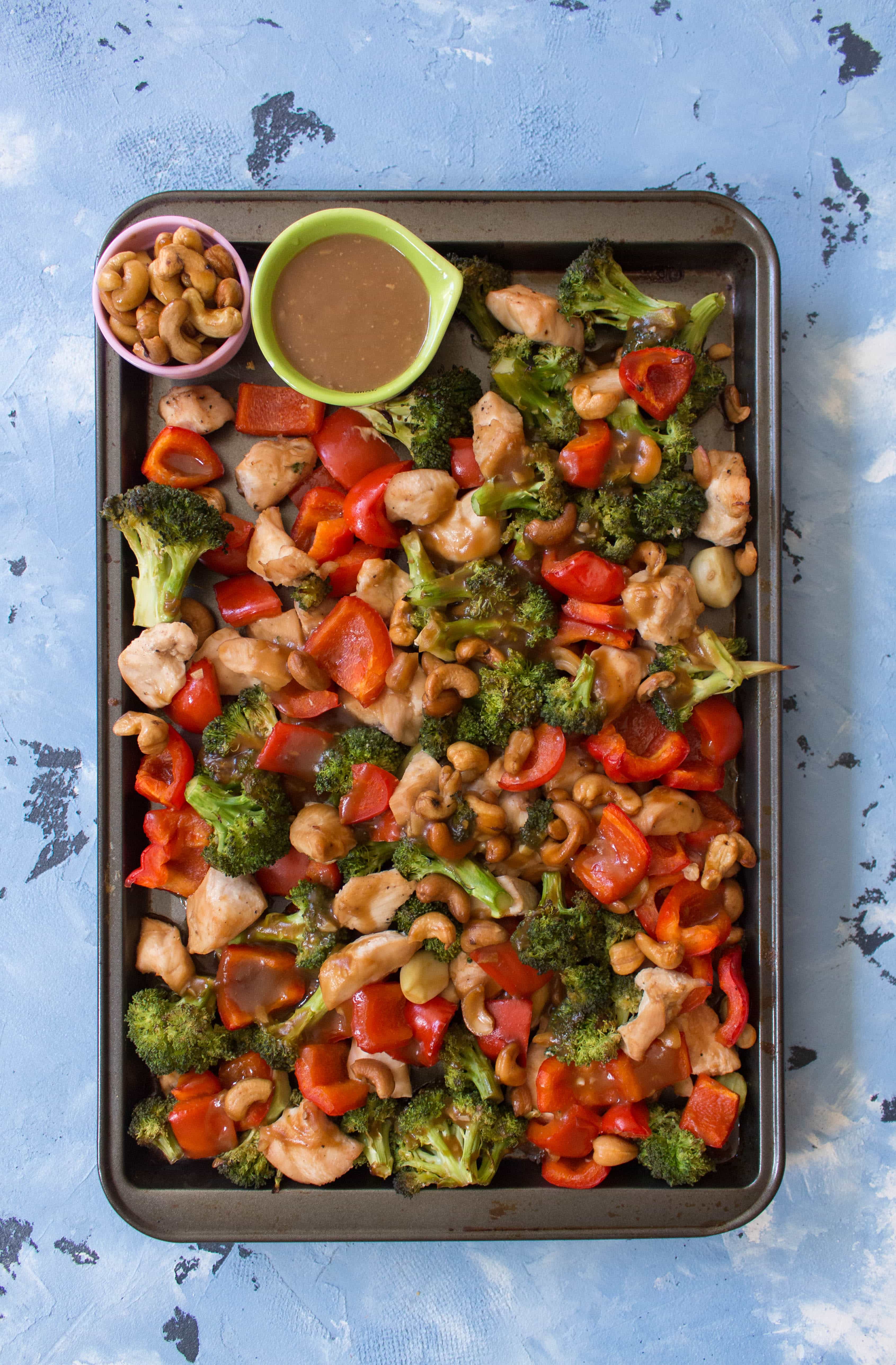 This One Sheet Pan Meal Prep: Cashew Chicken with Veggies is so easy and fast to make. My take on the popular Chinese takeout dish, my version only requires one pan to make and takes under an 45 minutes to make!