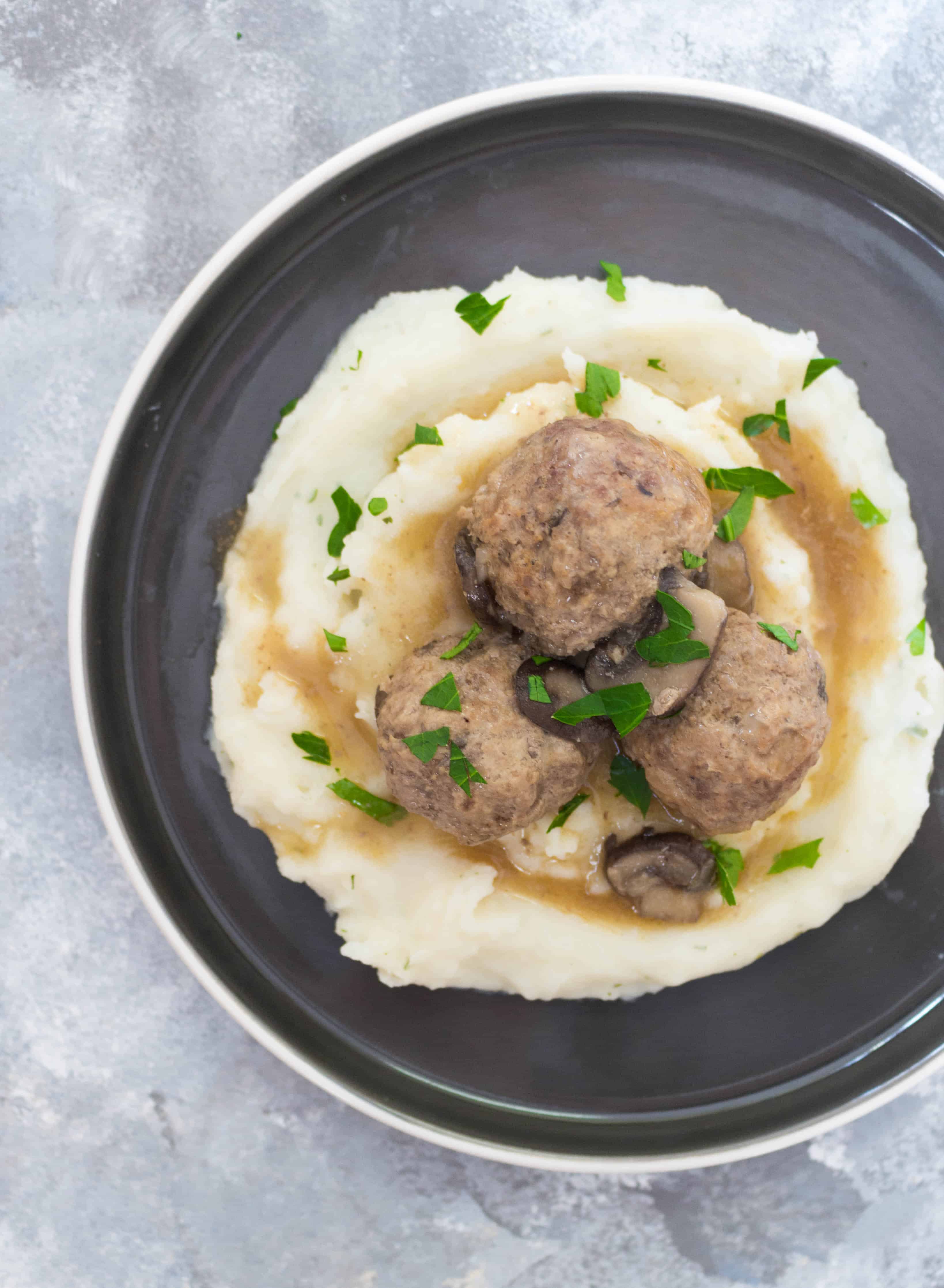 This Instant Pot Salisbury Steak Meatballs Recipe is inspired by the salisbury steak frozen dinners in the frozen food aisle. These yummy salisbury steak meatballs are lightened up by using both turkey meat and beef with mushrooms and take under 30 minutes to make!