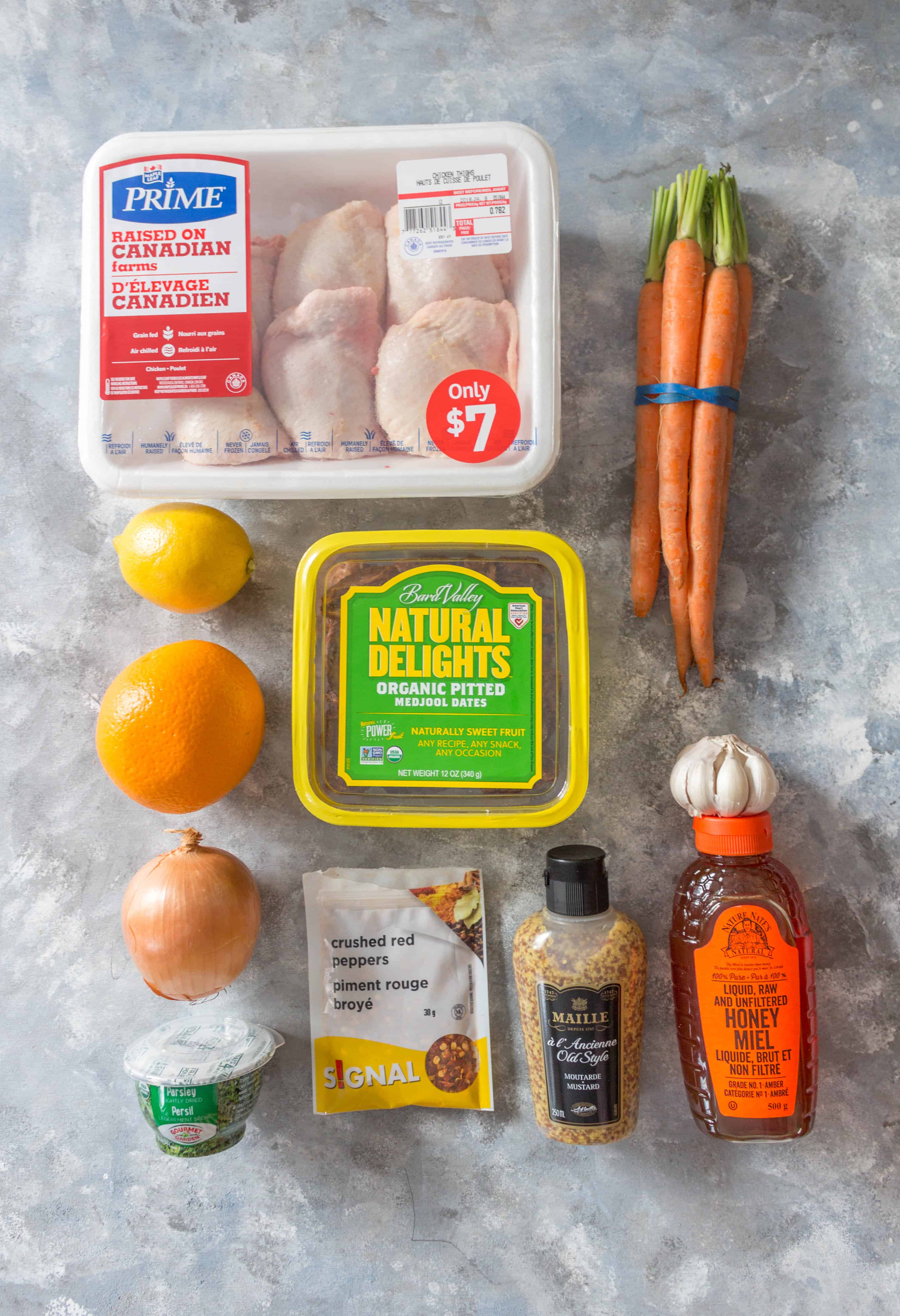 ingredients for sweet and savory chicken meal prep. dates, onions, lemon, orange, honey, mustard, chili flake, garlic