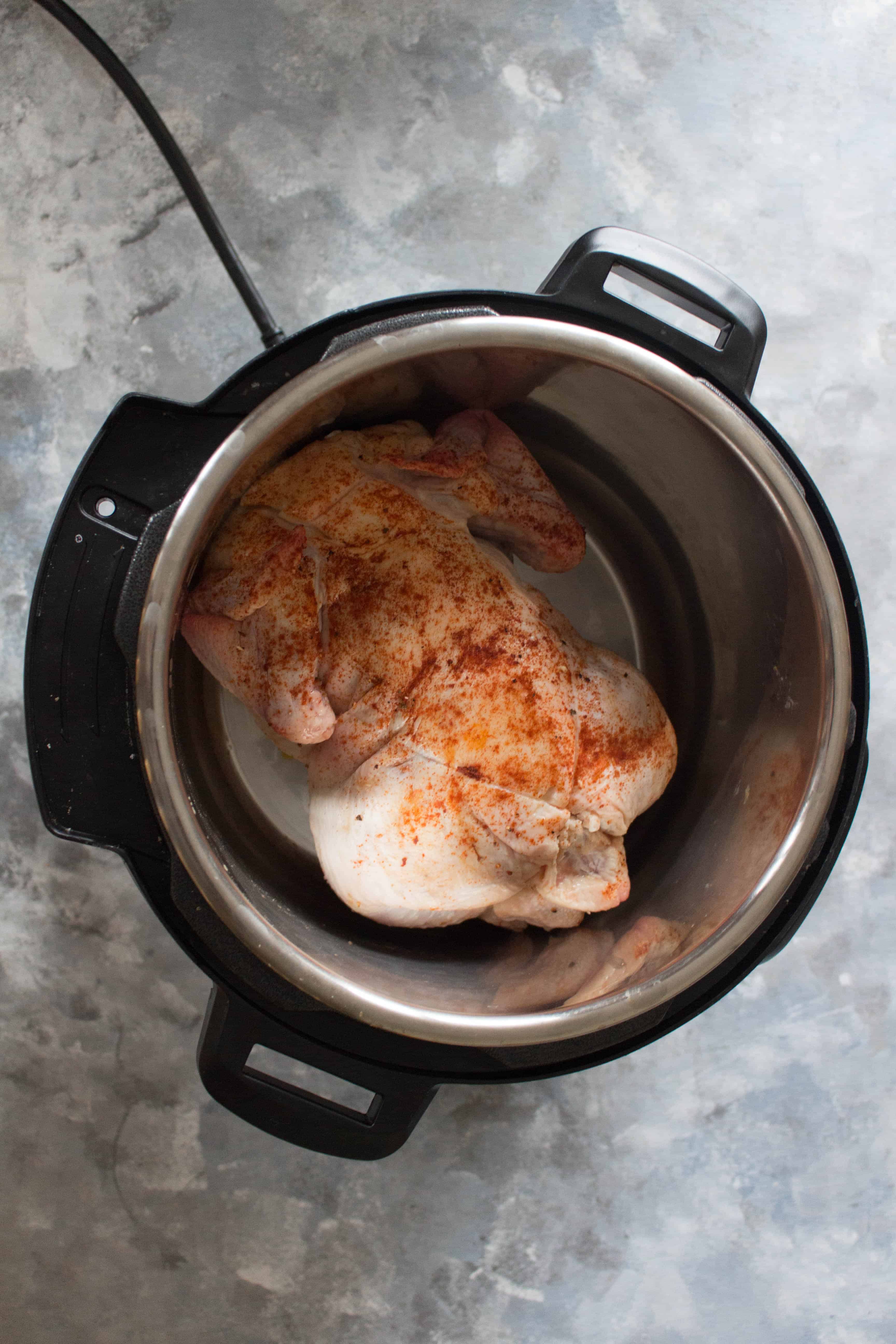 Seasoned Whole Chicken in Instant Pot | Curious as to how to cook a whole chicken in an Instant Pot? Keep reading to see how you can make a delicious, fall off the bone, and the juiciest whole chicken in an Instant Pot!