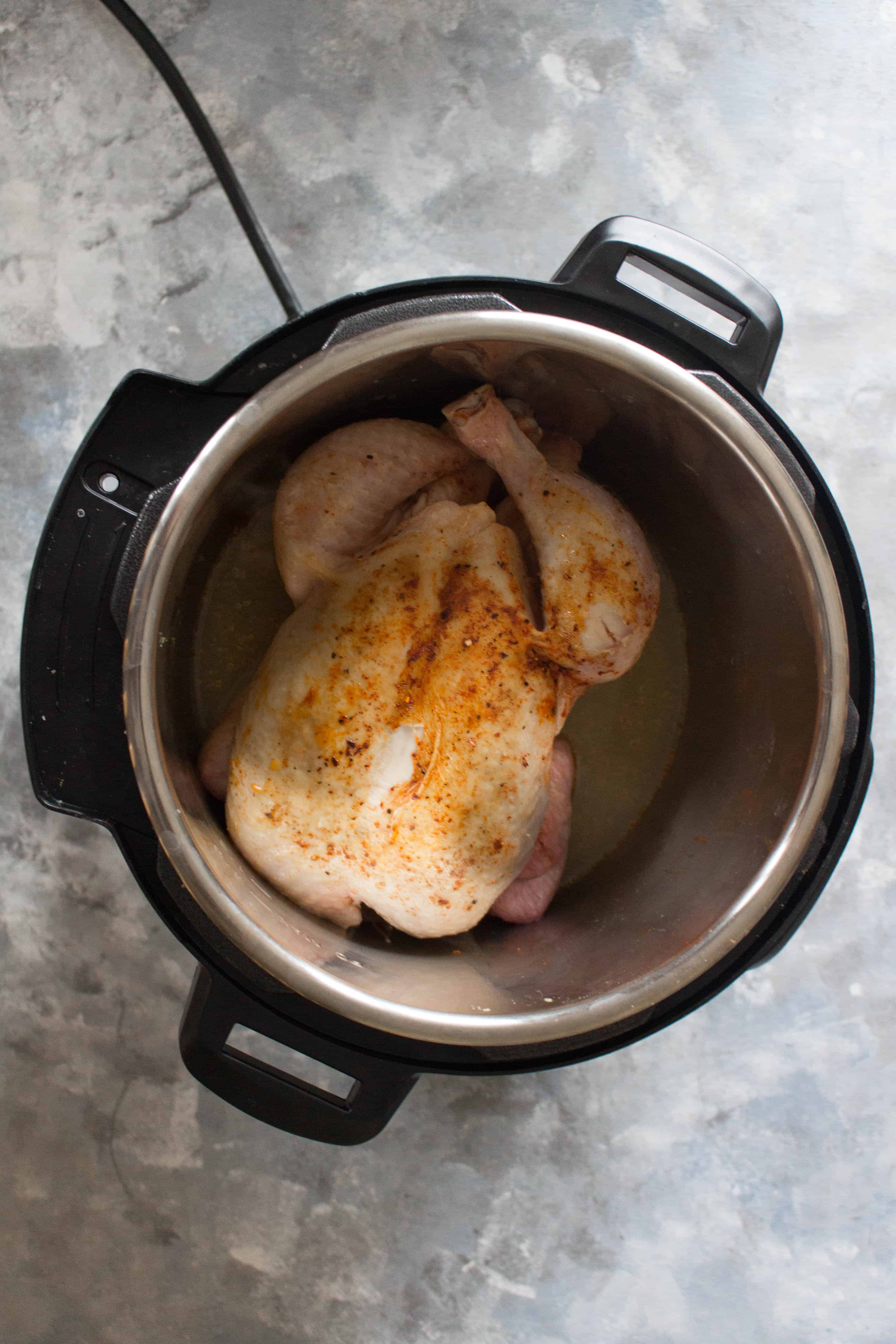 Flipped whole chicken in Instant Pot | Curious as to how to cook a whole chicken in an Instant Pot? Keep reading to see how you can make a delicious, fall off the bone, and the juiciest whole chicken in an Instant Pot!