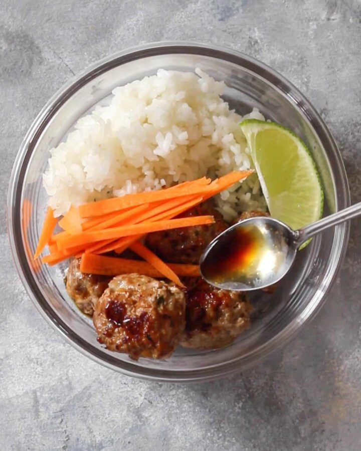 pouring sauce on bun cha meal prep | This Bun Cha Inspired Meatball Meal Prep can be made three ways: Instant Pot, Oven, and Stovetop! A classical Vietnamese recipe made easy!