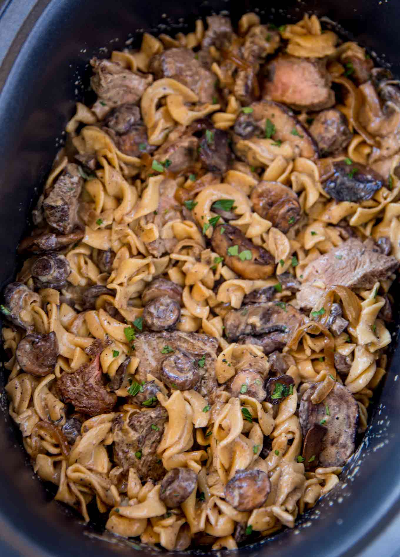 Slow Cooker Beef Stroganoff with tender, sliceable cuts of beef and noodles cooked together in the slow cooker with a rich creamy mushroom sauce.