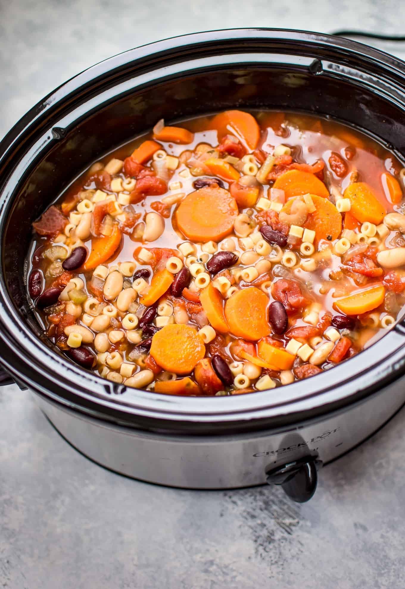 This Crockpot vegetarian pasta e fagioli soup recipe is a hearty and flavorful meatless meal that is easy to throw together