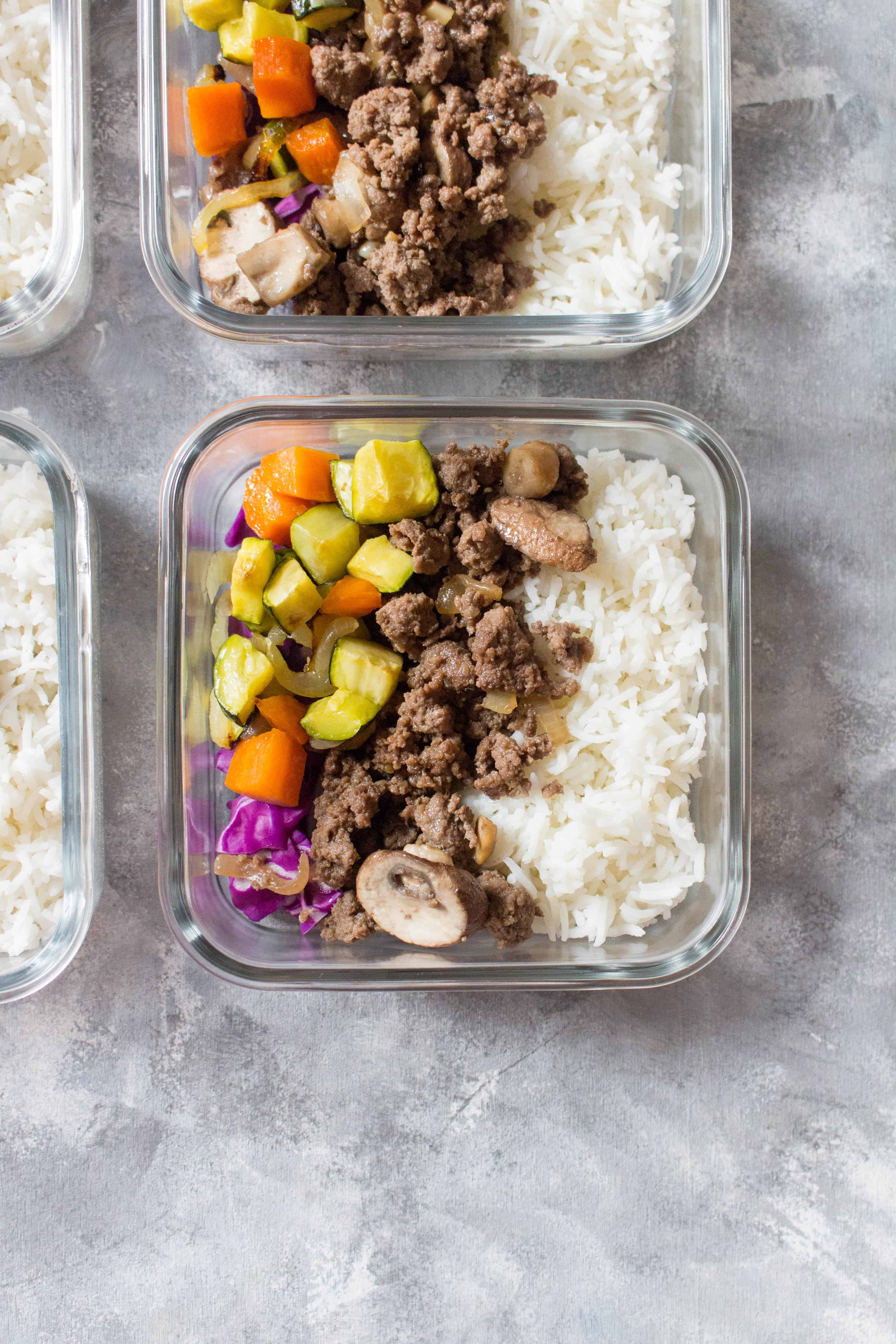 Meal prep containers with ground beef bulgogi bowls.