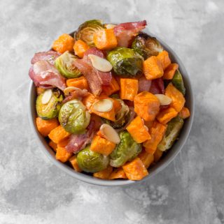 Looking for an easy holiday side dish? This Easy Roasted Brussels Sprouts with Sweet Potato, Bacon, and Almonds takes seconds to prep and goes with everything!