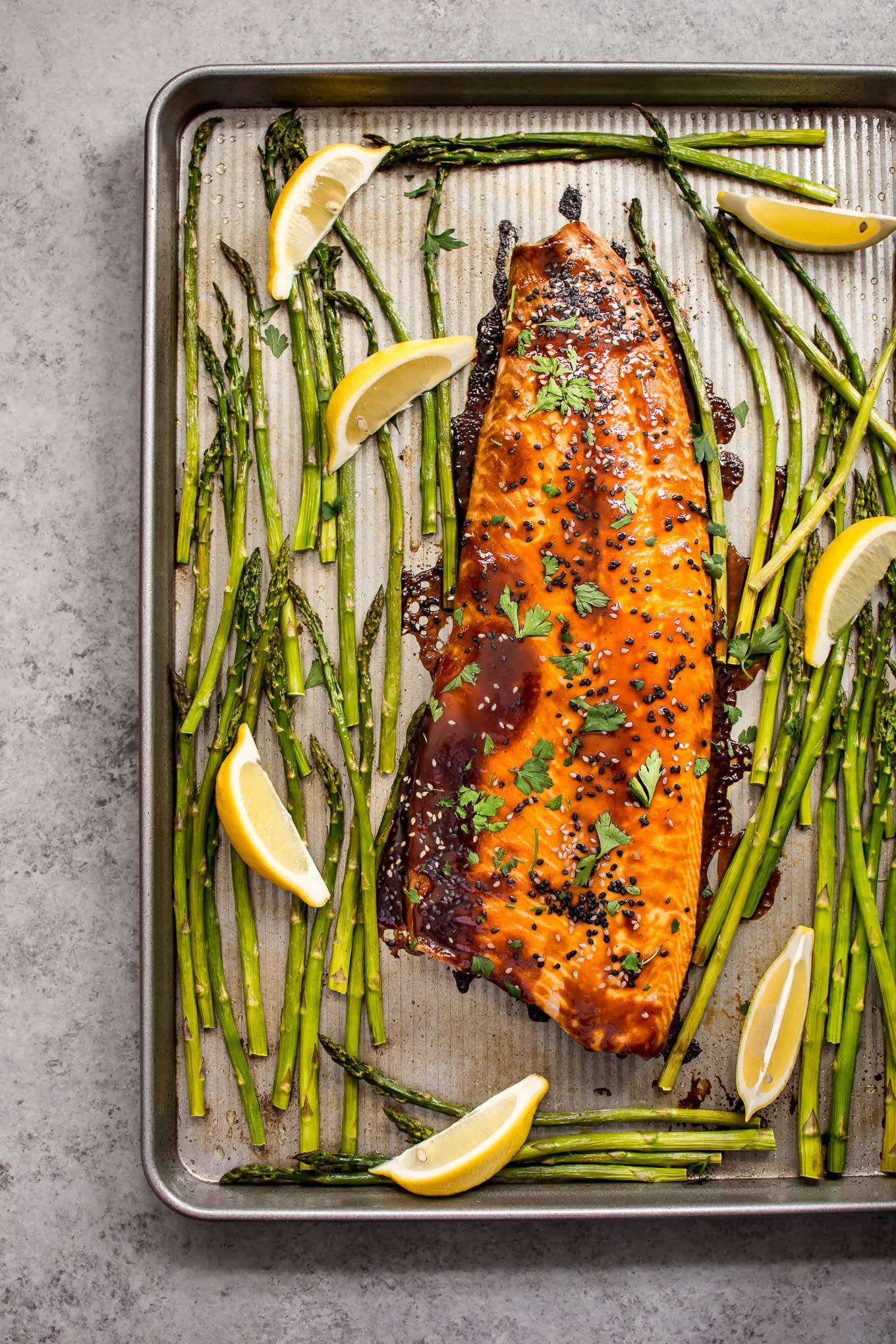 This quick and easy sheet pan salmon and asparagus makes a delicious dinner! The sweet hoisin sauce glaze will have everyone asking for seconds!