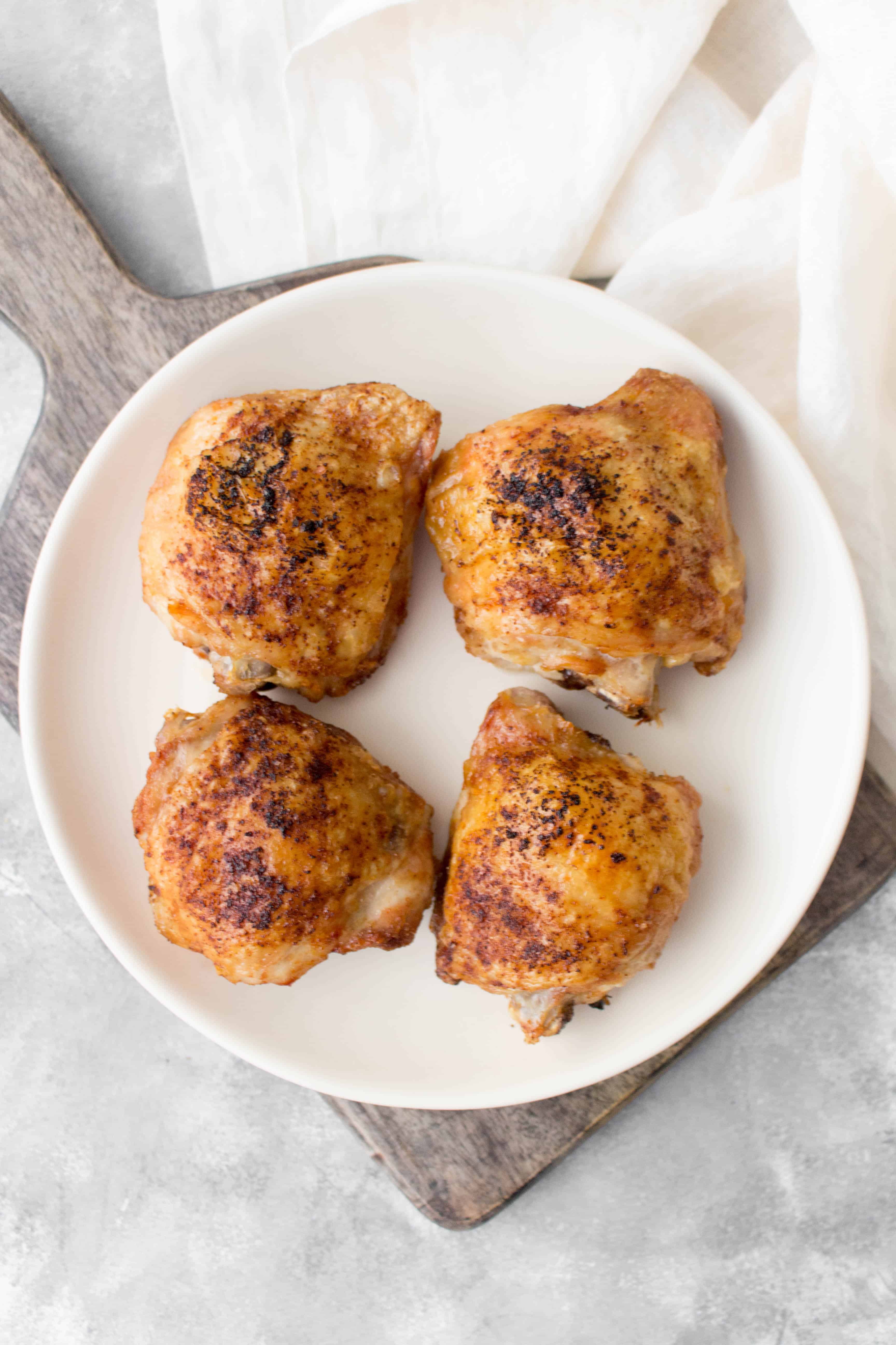 Want to how to make crispy chicken thighs in your air fryer? Here is my basic air fryer chicken thighs recipe that takes 25 minutes to make!