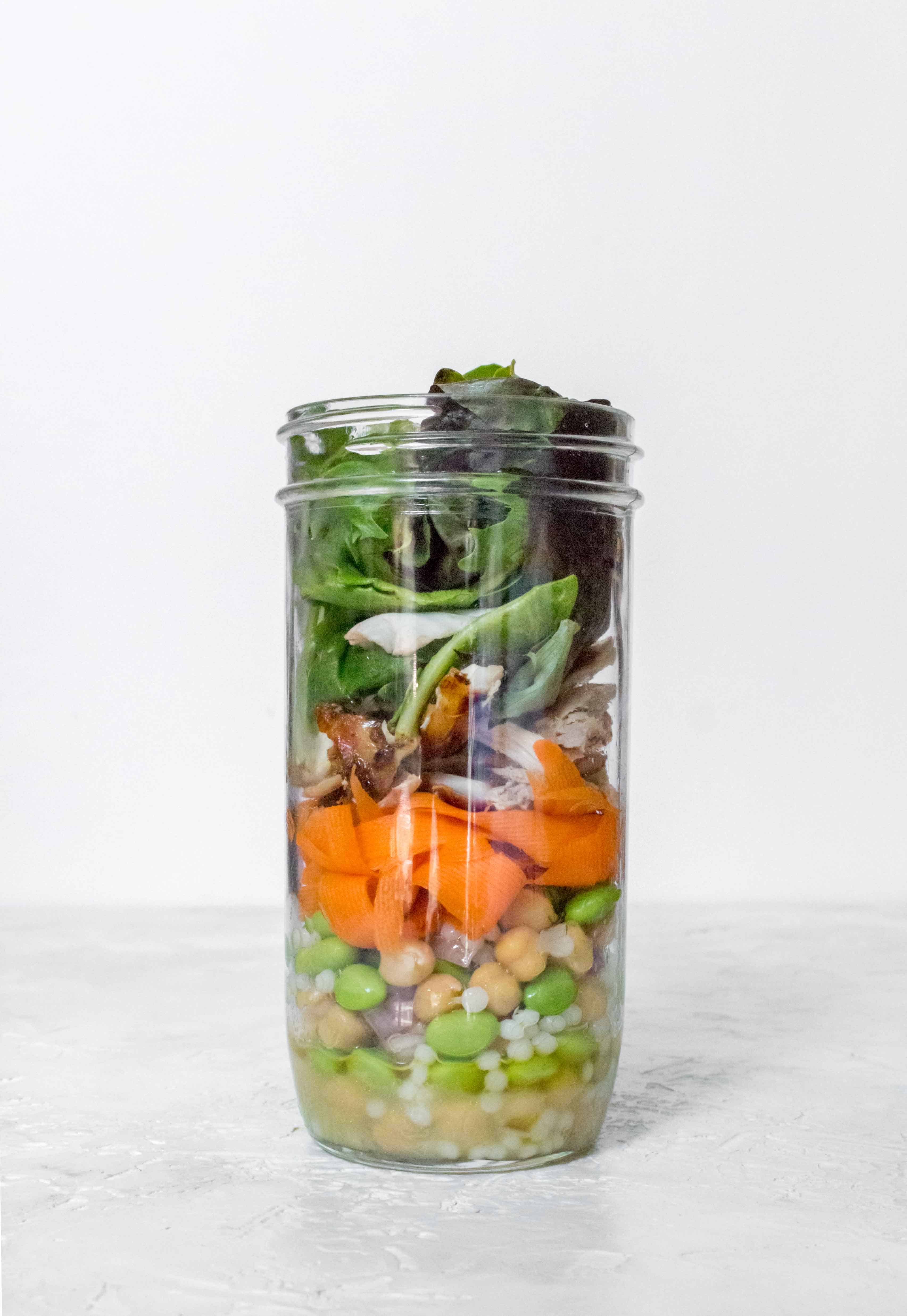 This Mason Jar Edamame Chickpea Salad with Couscous toss in a simple dressing, is perfect as a meal or as a side!
