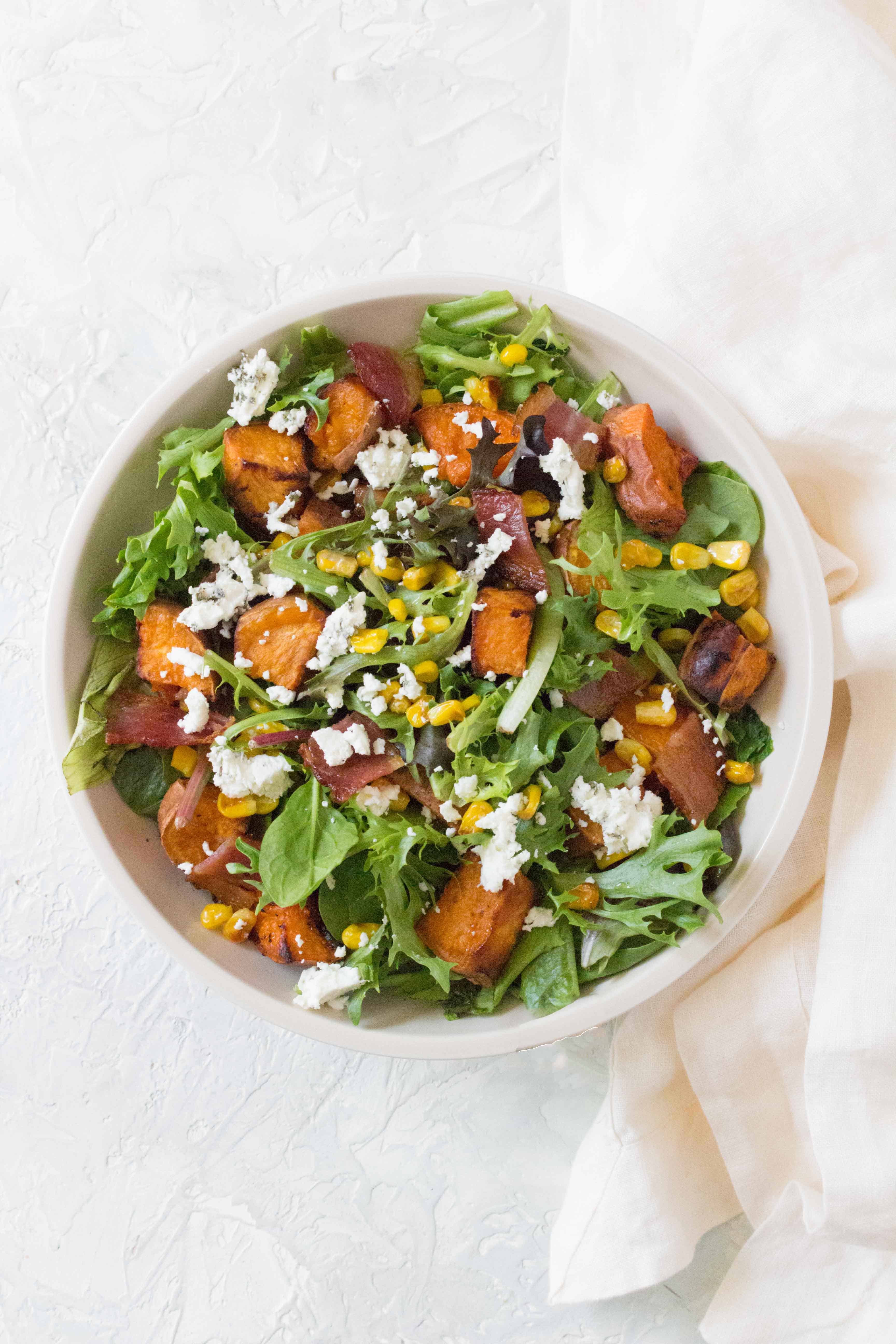 This Roasted Sweet Potato Salad with Corn and Bacon is the perfect salad for your next get together!