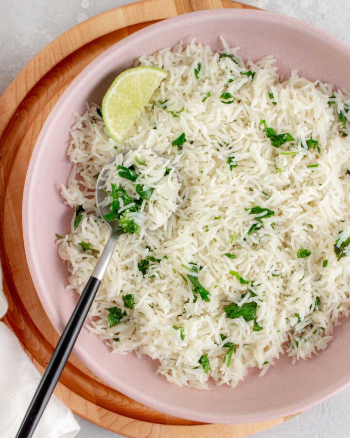 a bowl of instant pot coconut lime rice with a spoon.