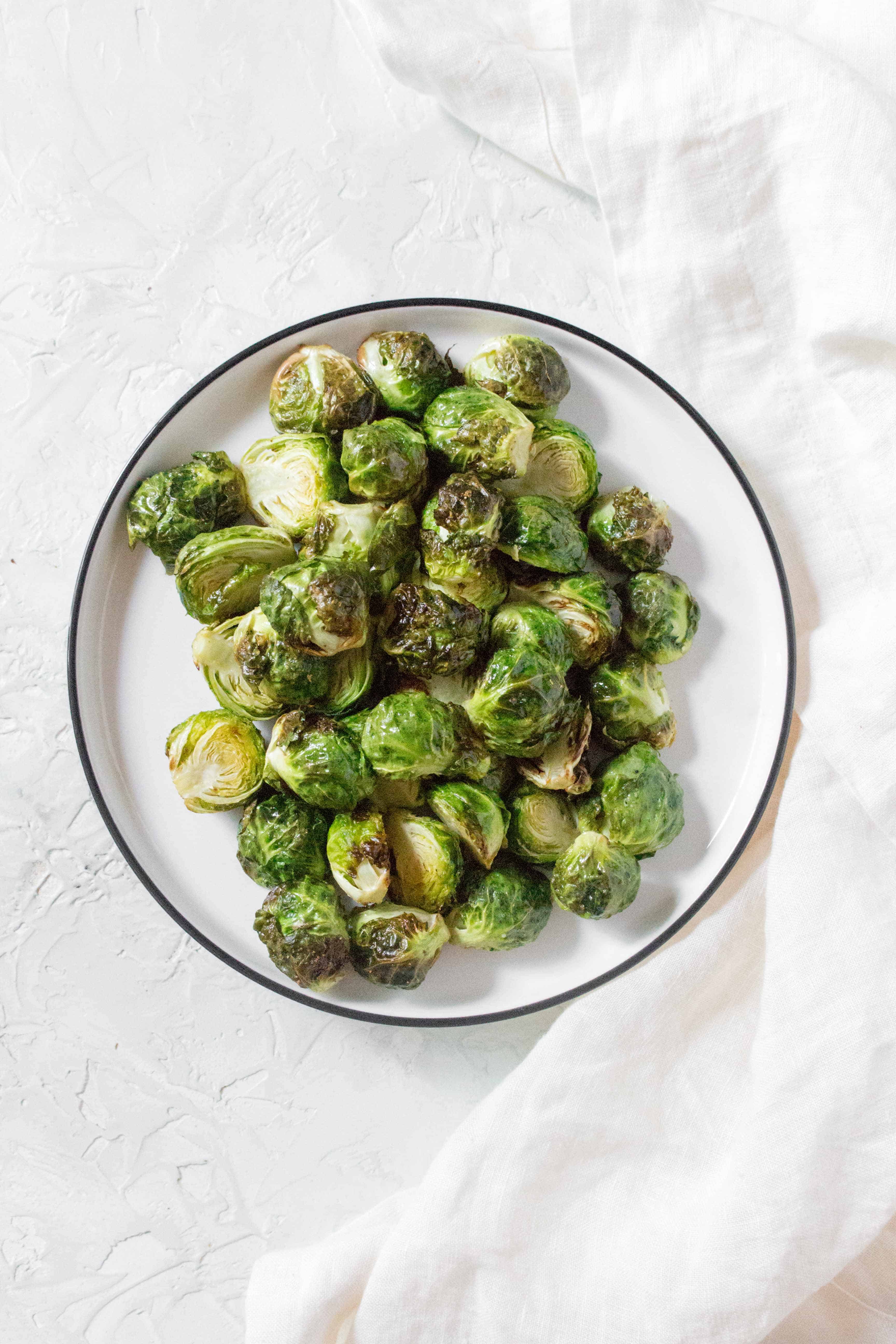 Crispy on the outside, and perfectly tender on the inside, these air fryer Brussels sprouts are going to be a hit! Here's how to make Crispy Air Fryer Brussels Sprouts!