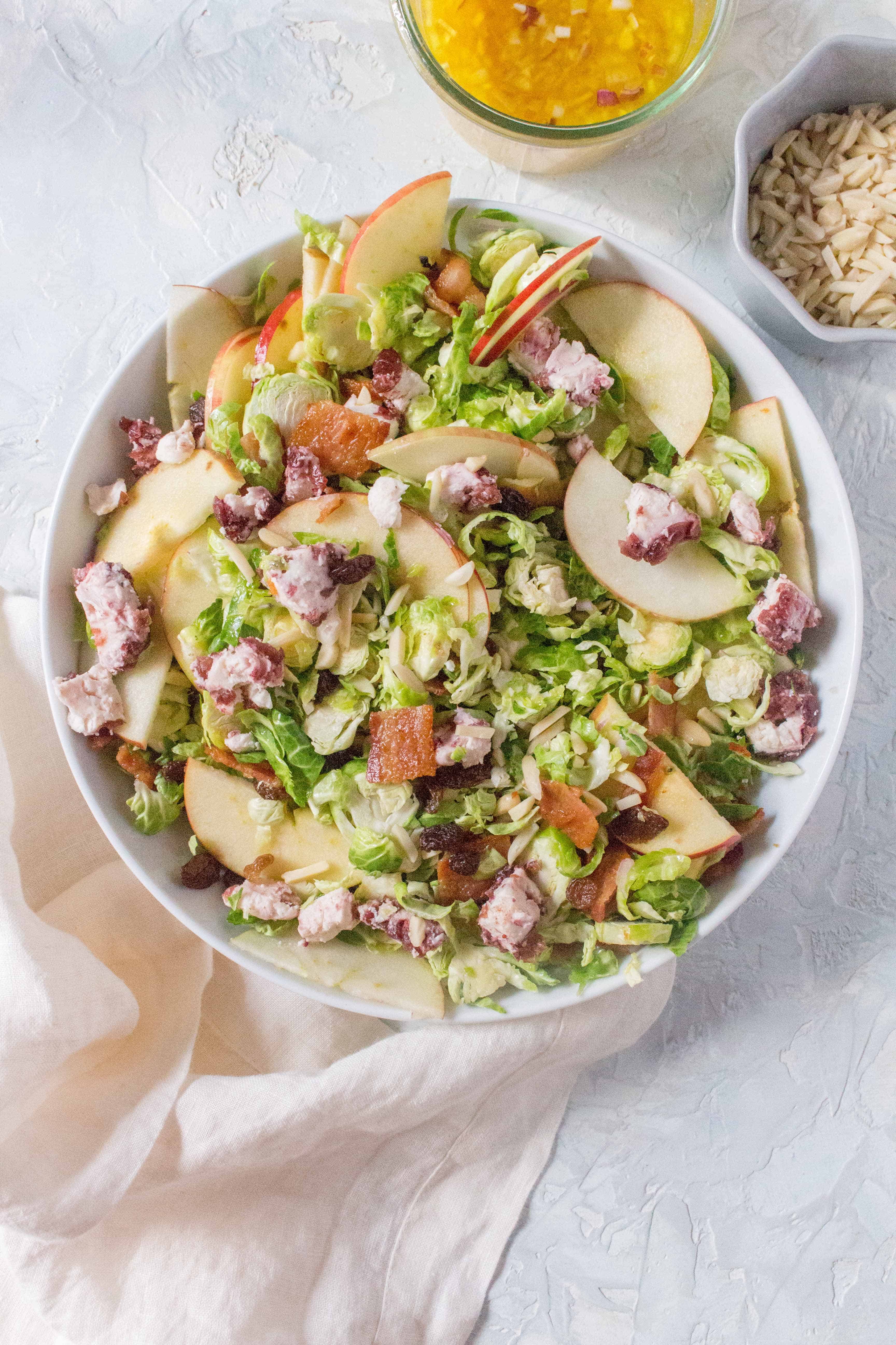 Quick and easy to put together, you're going to want to make this Easy Shaved Brussels Sprouts Salad for your next holiday meal! Plus you can make Shaved Brussels Sprouts Salad Recipe a day ahead of time to cut down on that holiday dinner stress!