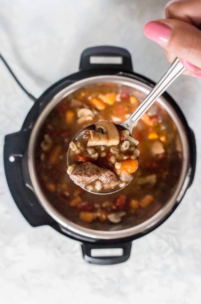 Super rich, freezer friendly, and delicious, this Instant Pot Beef and Barley Soup is comfort in a bowl!