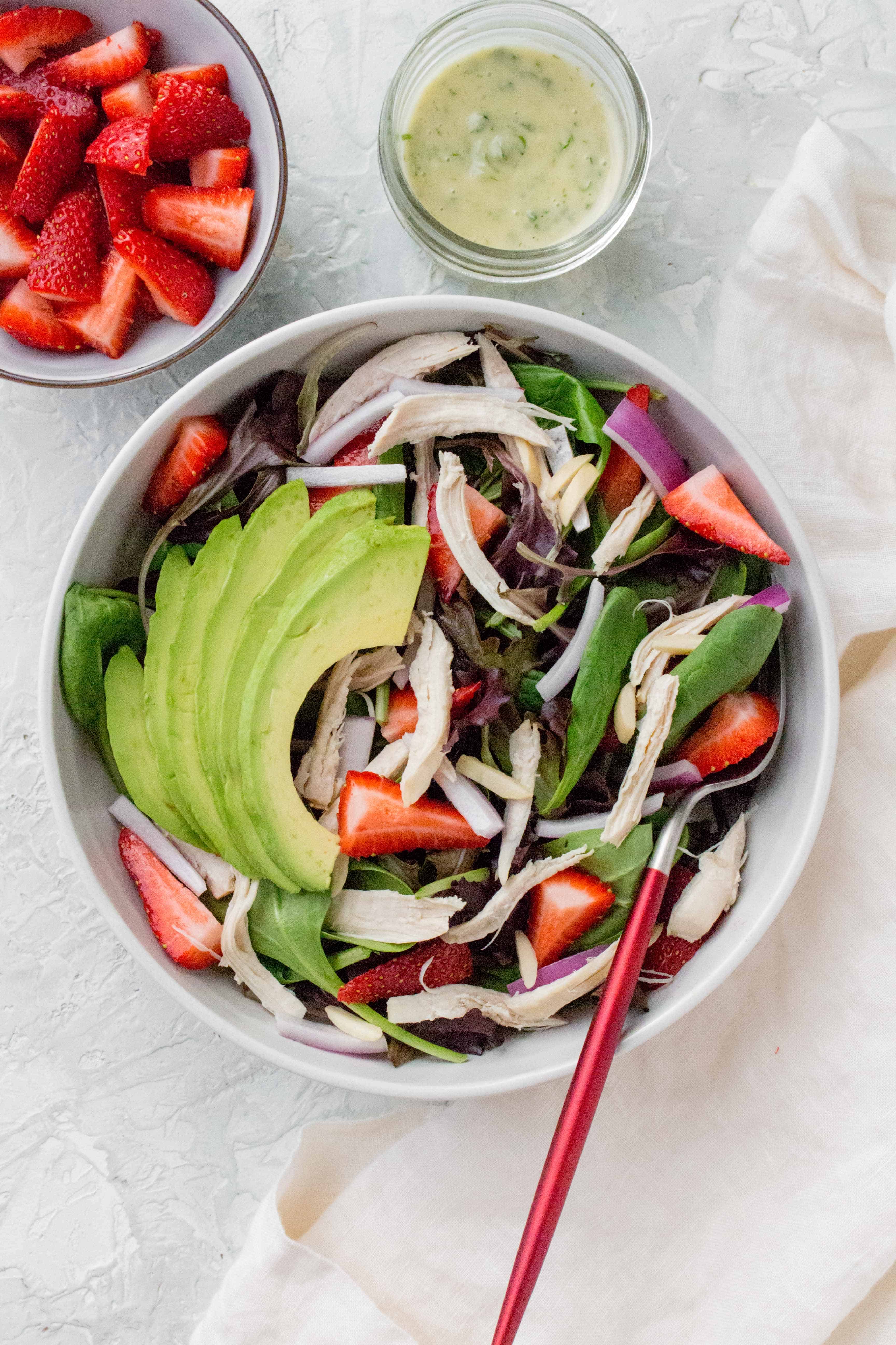 Refreshing and bright, this Chicken Strawberry Avocado Salad is a not-boring salad that works as the perfect cold lunch idea, light dinner, or as a potluck dish! 