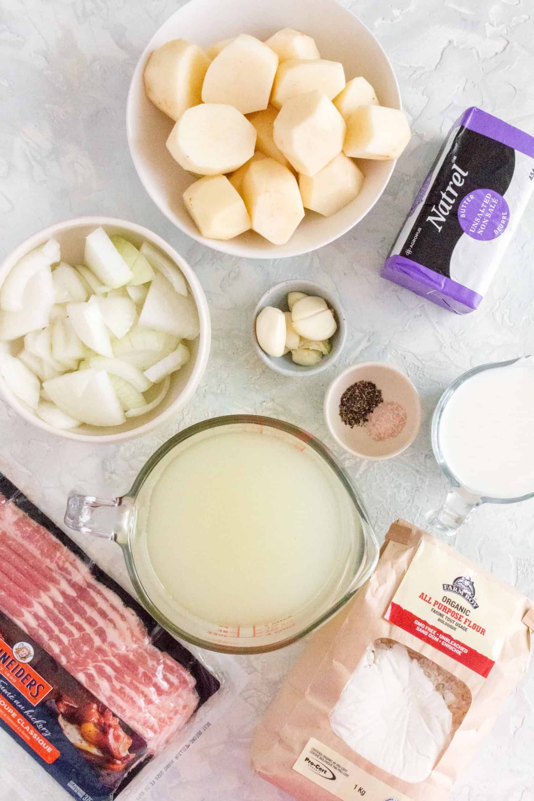 What You Need To Make Potato Soup in the Instant Pot. Ingredients shown: potato, garlic, onion, bacon, stock, flour, butter, milk, salt, pepper