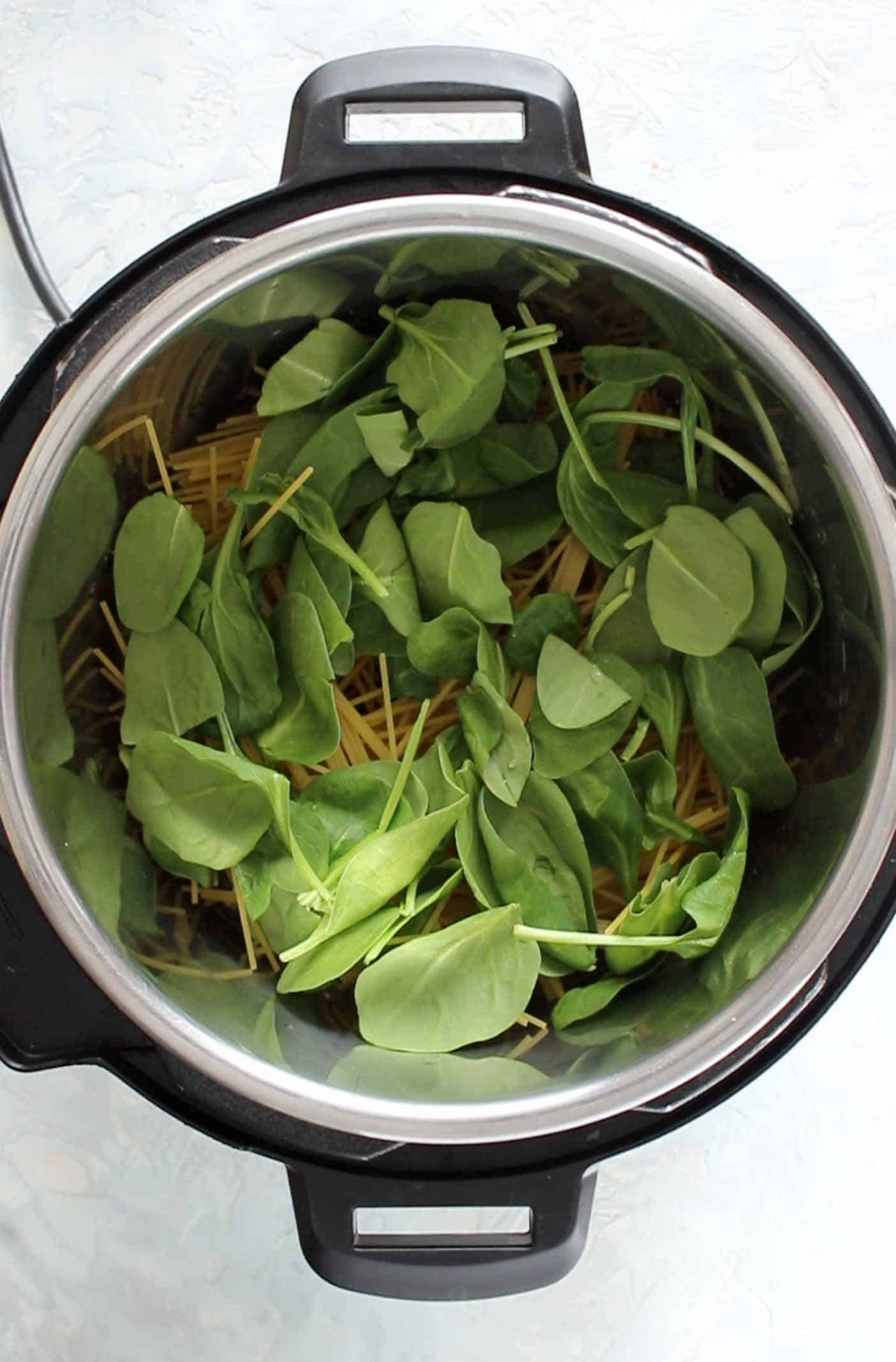 layering in spinach on top of instant pot spaghetti
