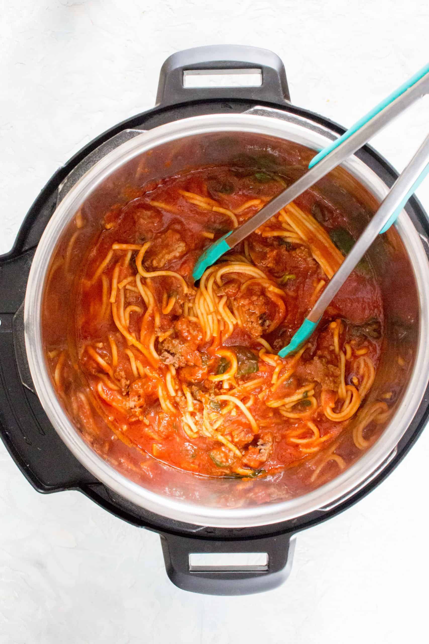 tongs mixing instant pot spaghetti