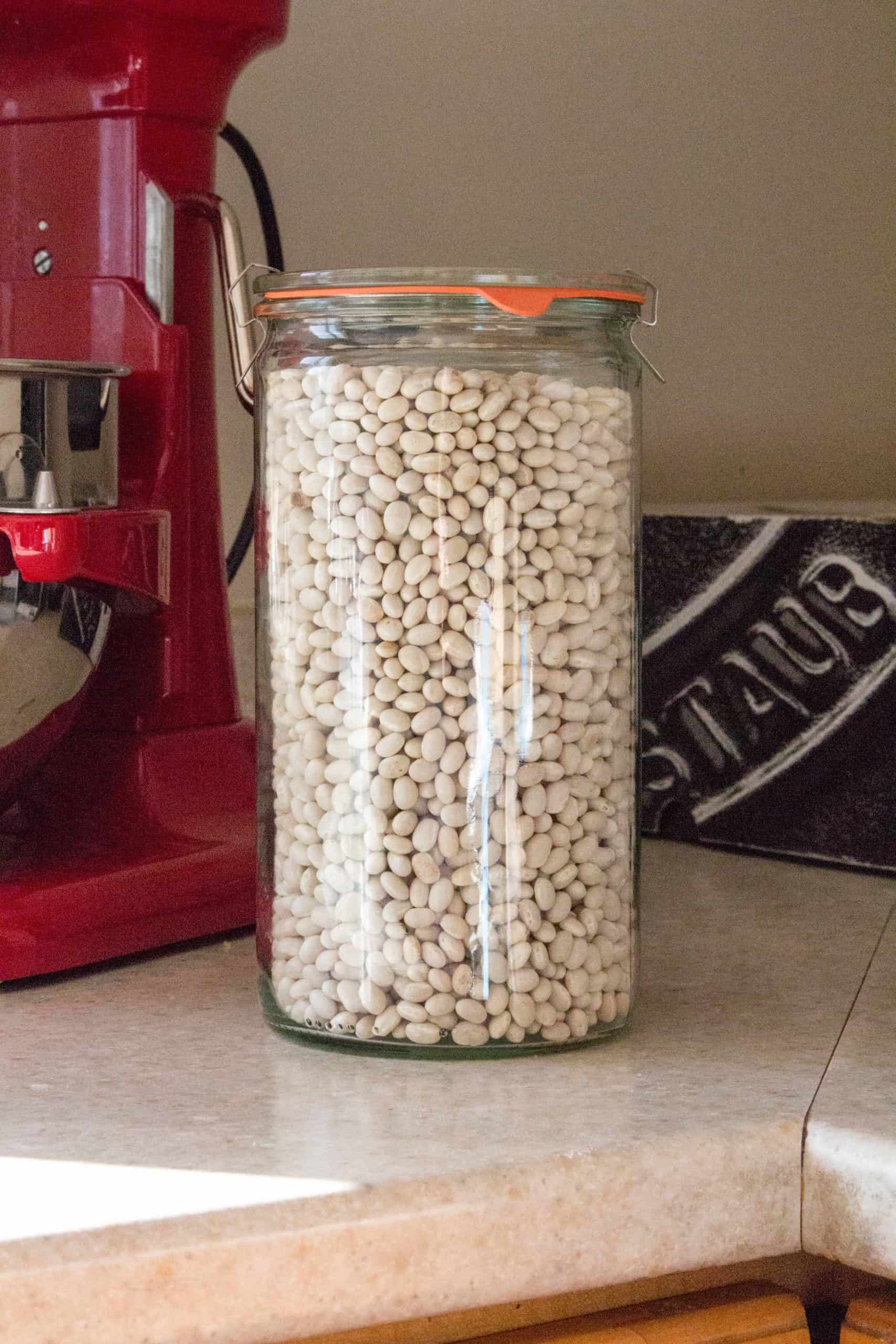 dried navy beans in a glass container