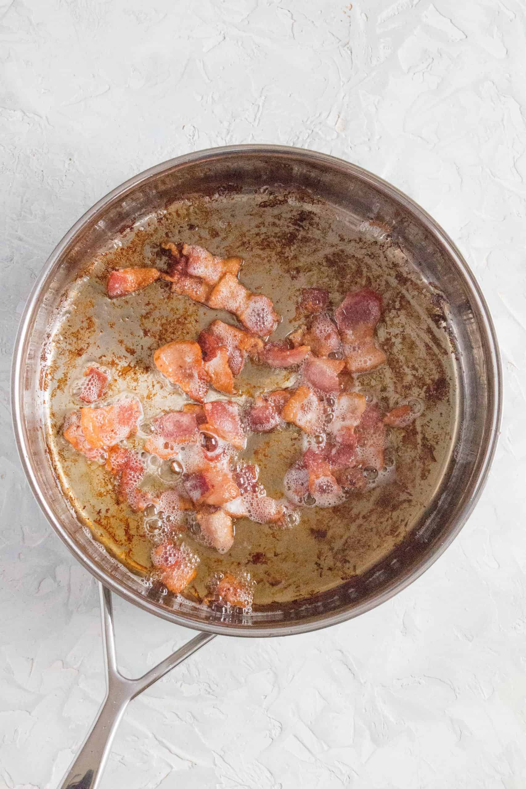 While the water is boiling, in a medium sized pan, fry your bacon until crispy.