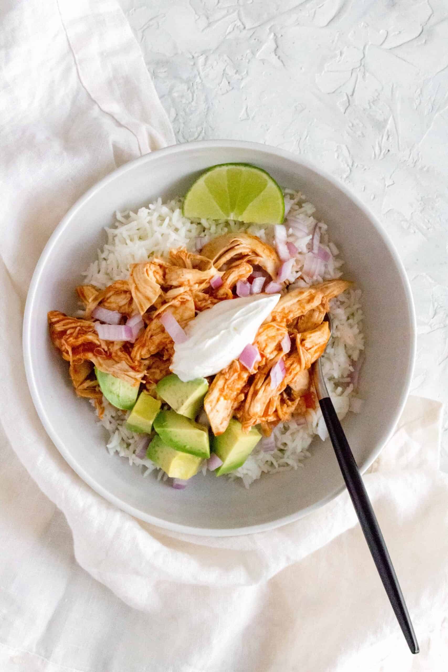 This Instant Pot Cilantro Lime Salsa Chicken is so easy to make! Use the shredded chicken in a bowl, tacos, or burritos!