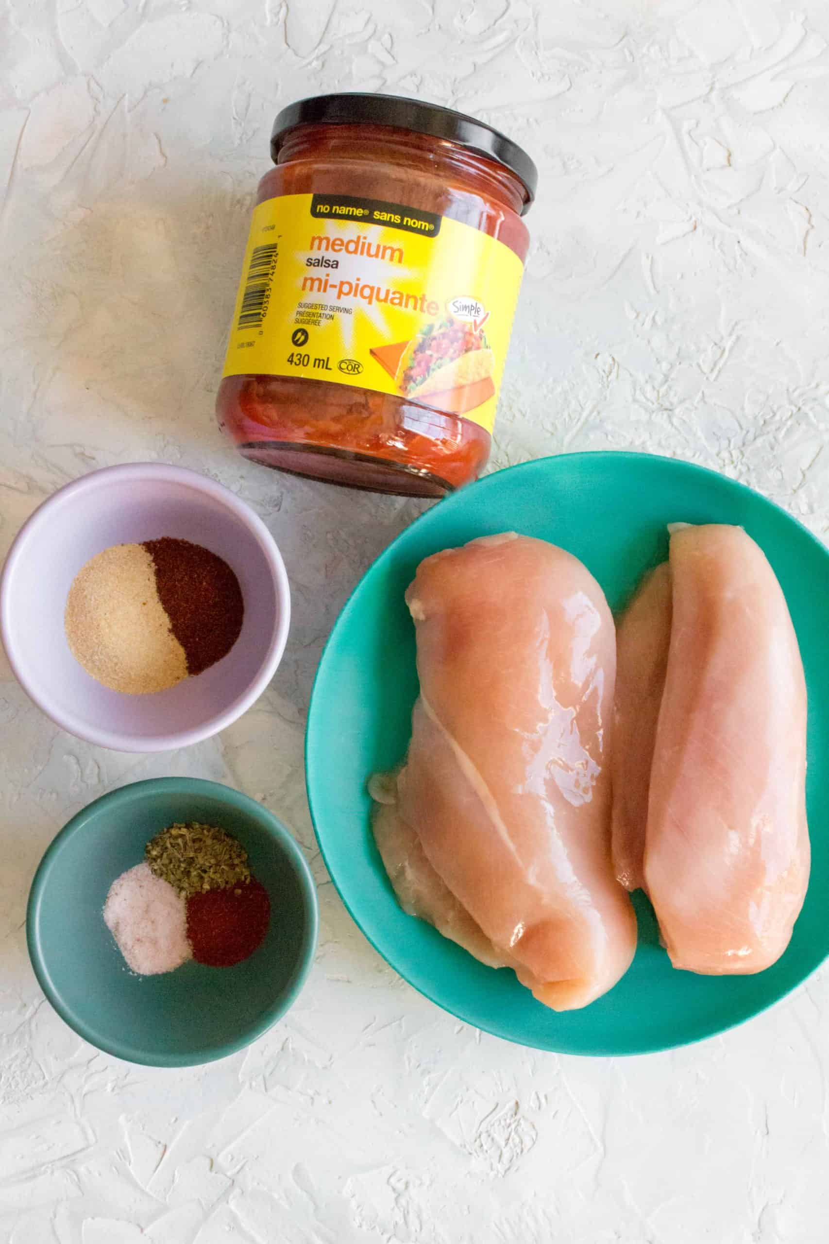 ingredients for instant pot shredded salsa chicken: chicken breasts, seasonings, salsa