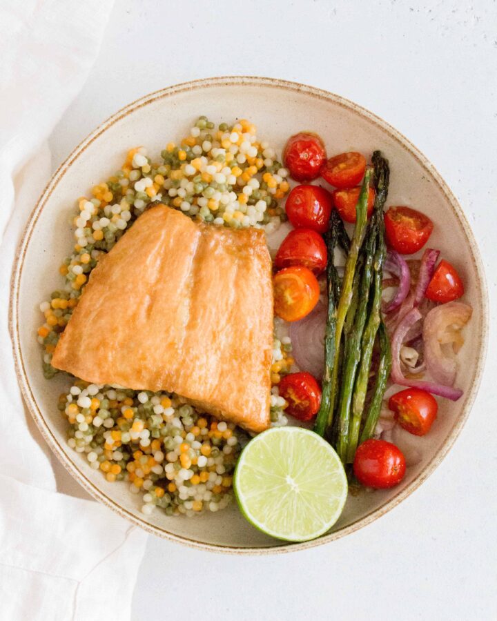 This Sheet Pan Honey Soy Salmon is the easiest dinner! This sheet pan salmon dinner only takes 15 minutes to cook after marinating!