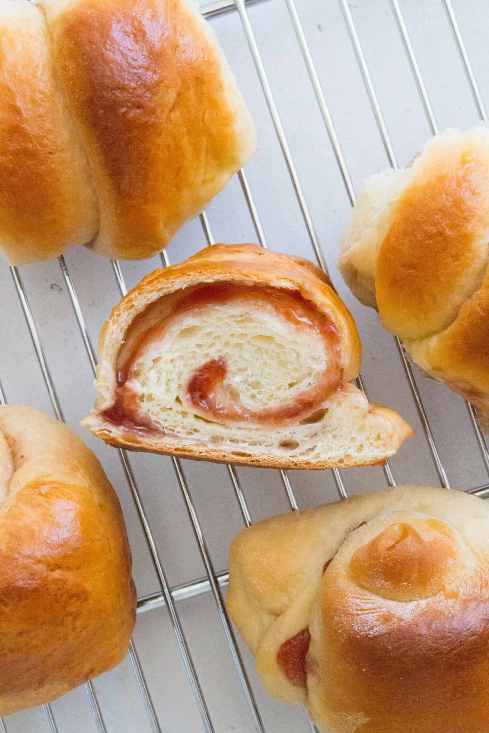 Here's how you can make strawberry swirled, fluffy, pillowy soft Hokkaido style milk bread rolls at home with this simple recipe. The perfect make ahead bread as they stay soft for days! Try these Japanese Milk Bread Rolls tonight!