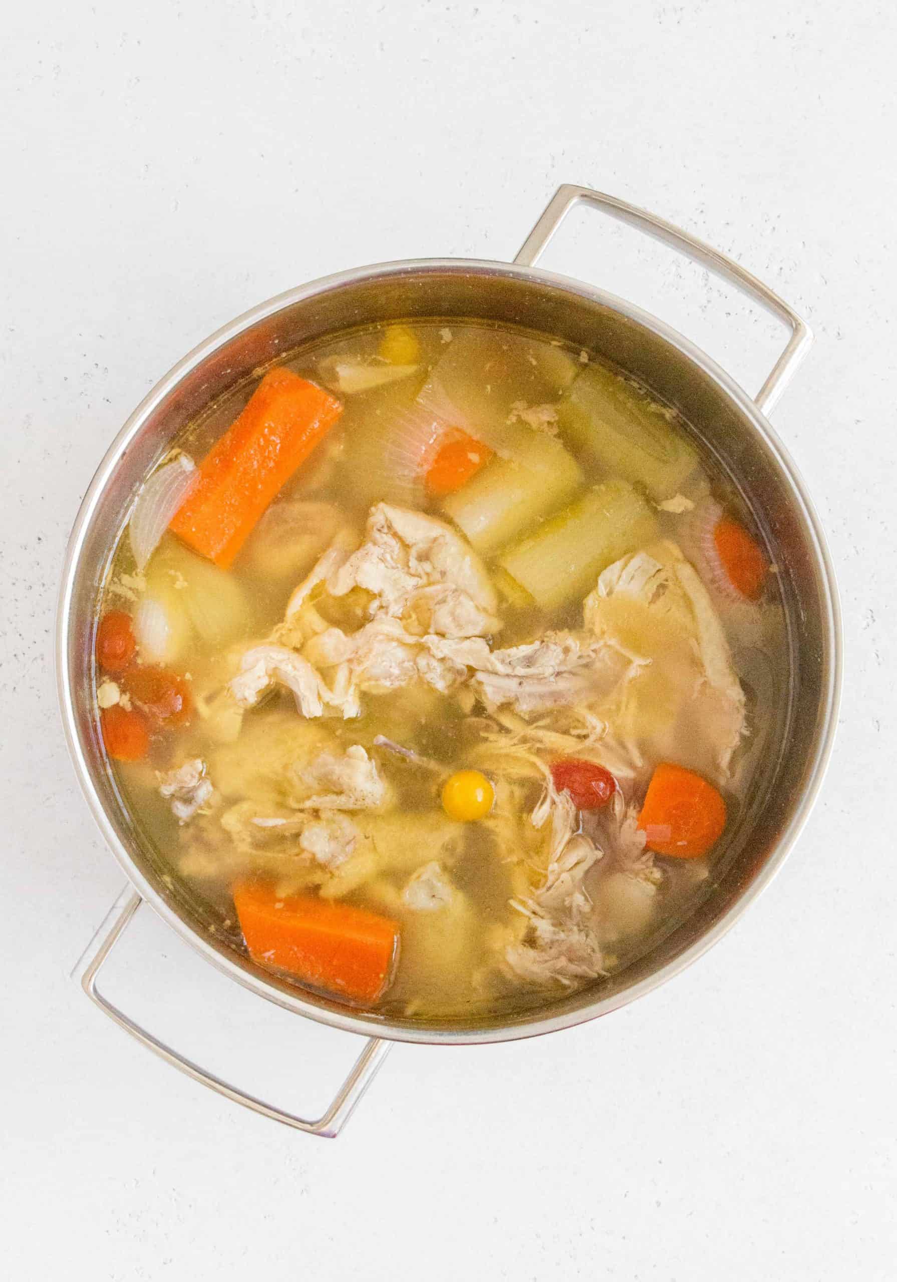 A pot of chicken broth, simmering.