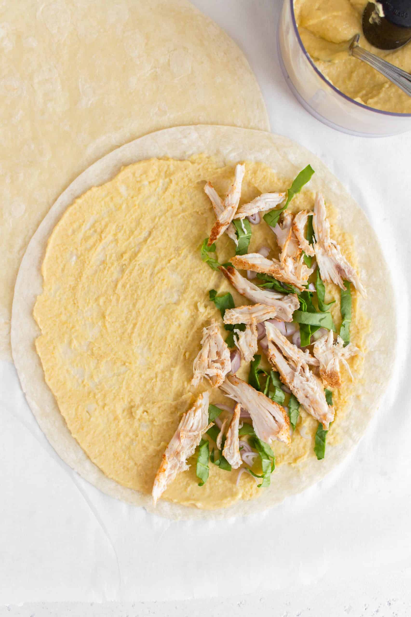 tortilla with hummus, spinach, shallots, and chicken.