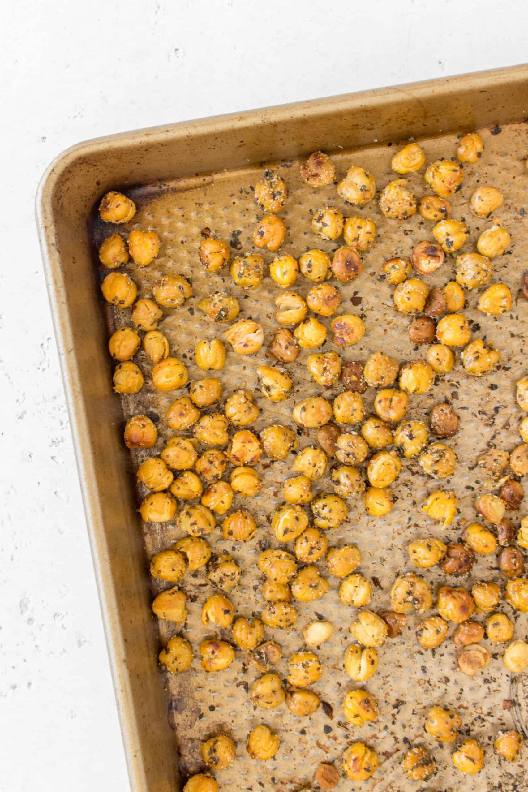 Roasted chickpeas with garlic and basil in a sheet pan.