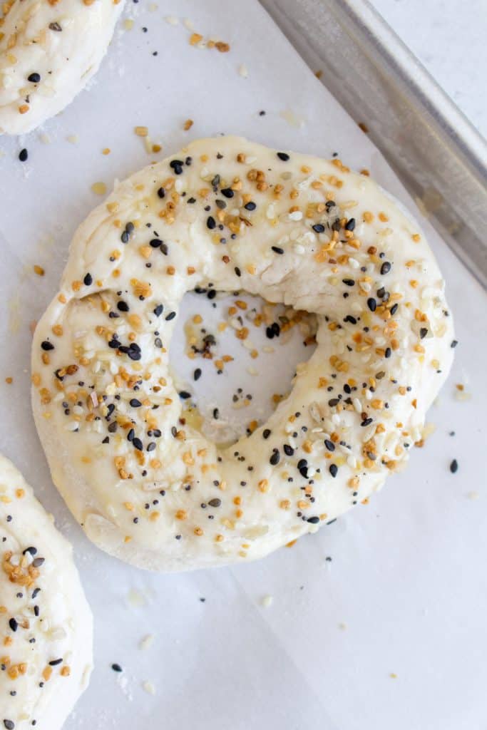 egg wash and top off bagel with seasoning