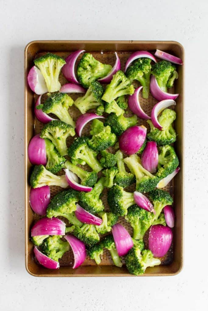 sheet pan with broccoli and red onions