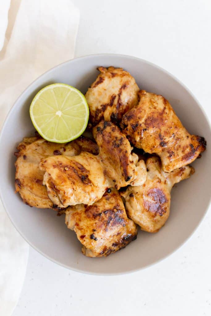 bowl of chicken thighs with lime