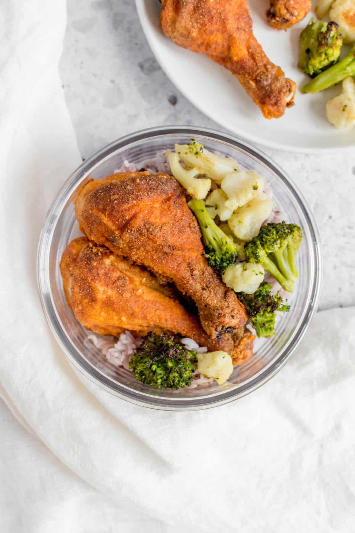 baked drumsticks in a meal prep container