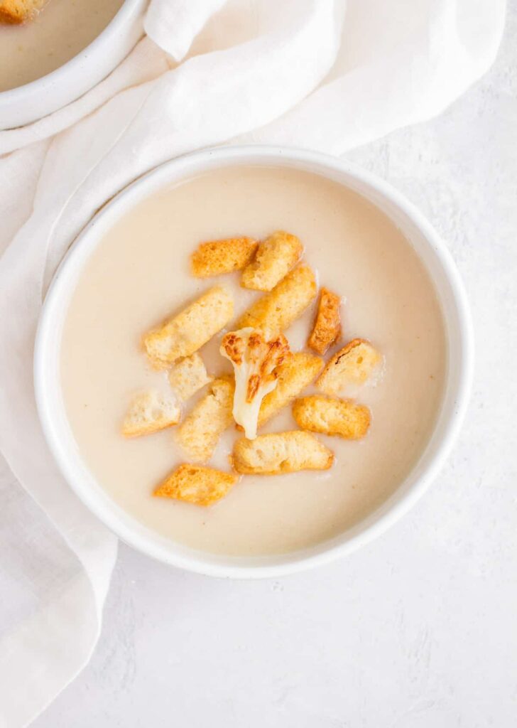 white bowl with garlic and cauliflower soup
