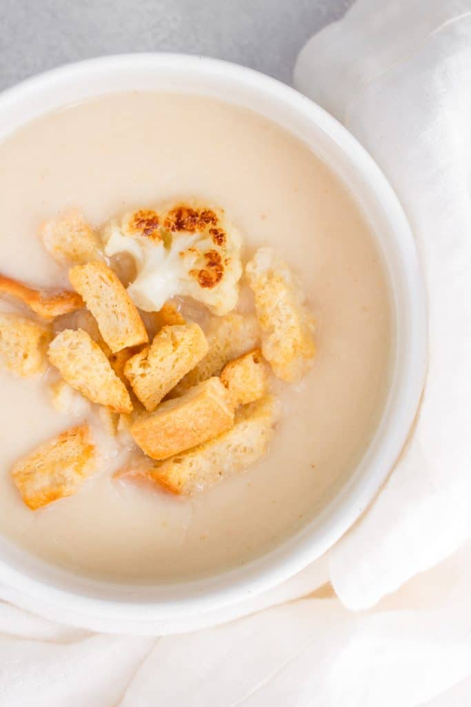 close up of roasted cauliflower soup with croutons