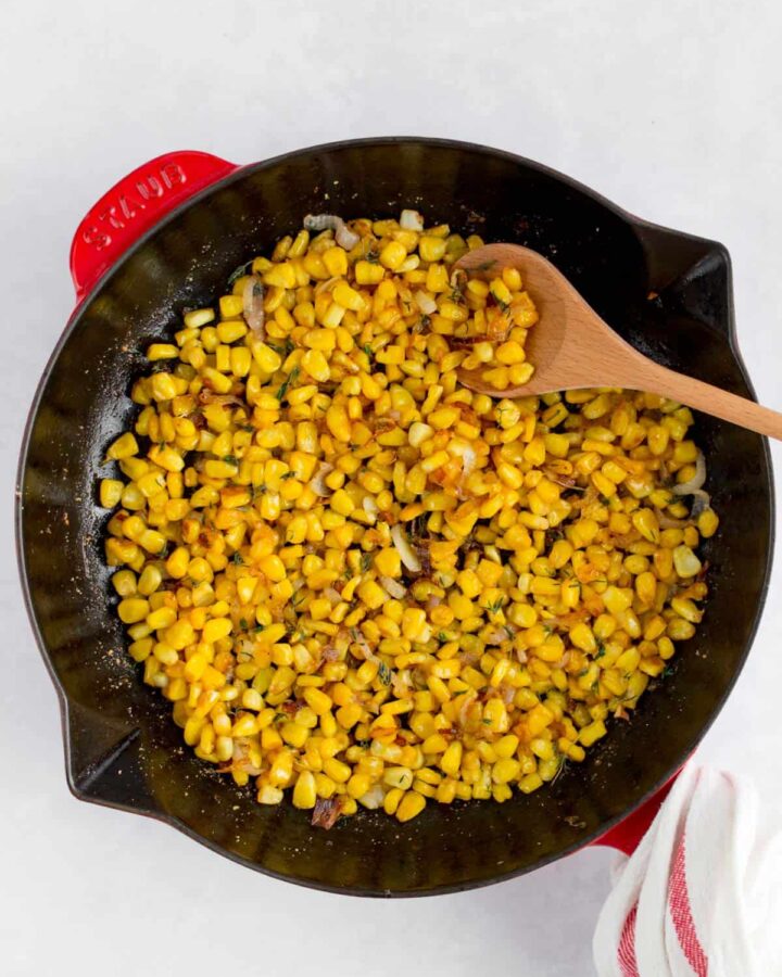 Caramelized corn with shallots in a staub frying pan.