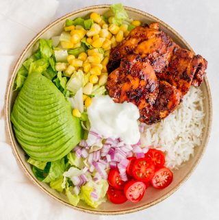 A chicken burrito bowl with honey chipotle chicken thighs.
