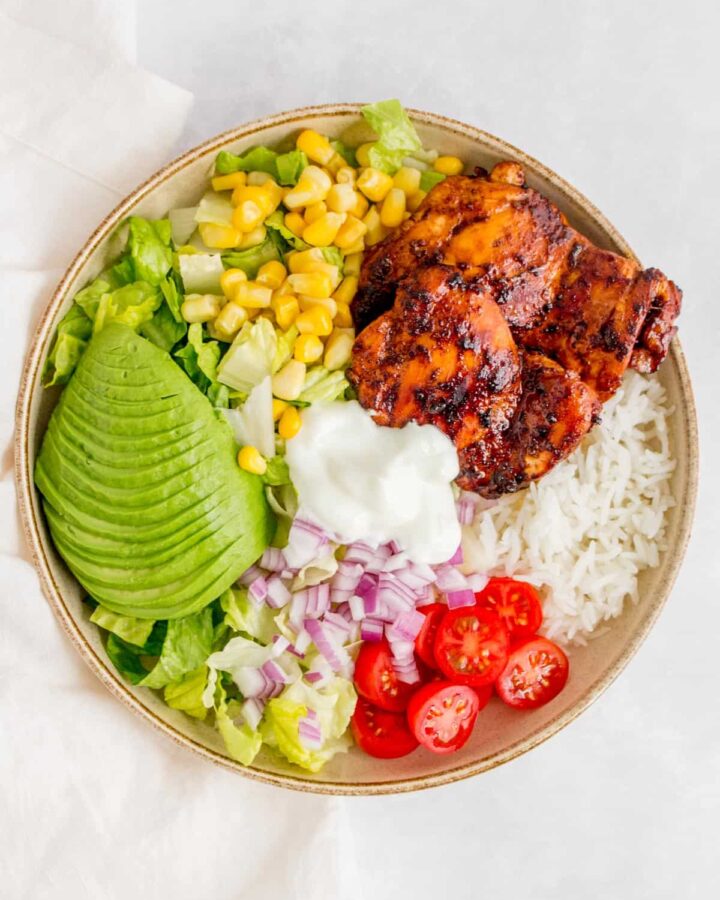A chicken burrito bowl with honey chipotle chicken thighs.