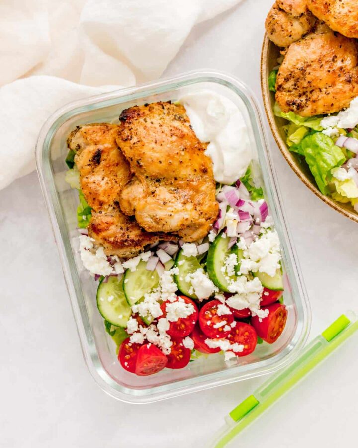 Herb chicken meal prep salad in a glass container.