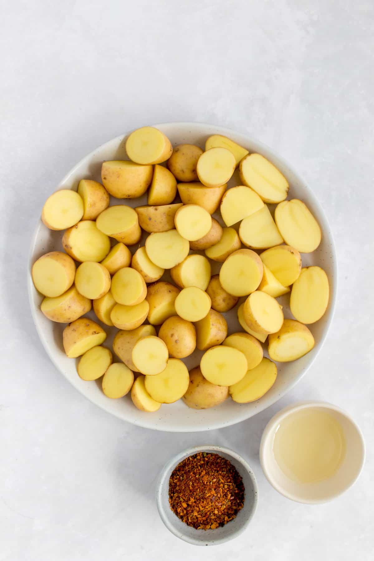 Overhead photo of baby potatoes and seasoning.