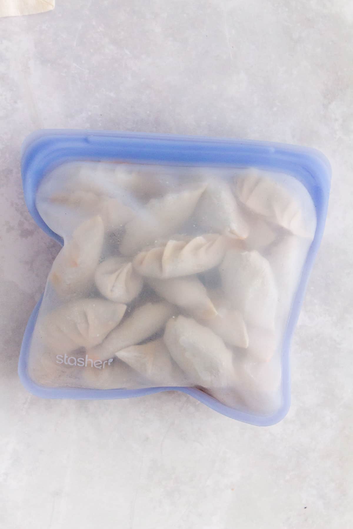 Frozen dumplings in a silicone stasher bag.