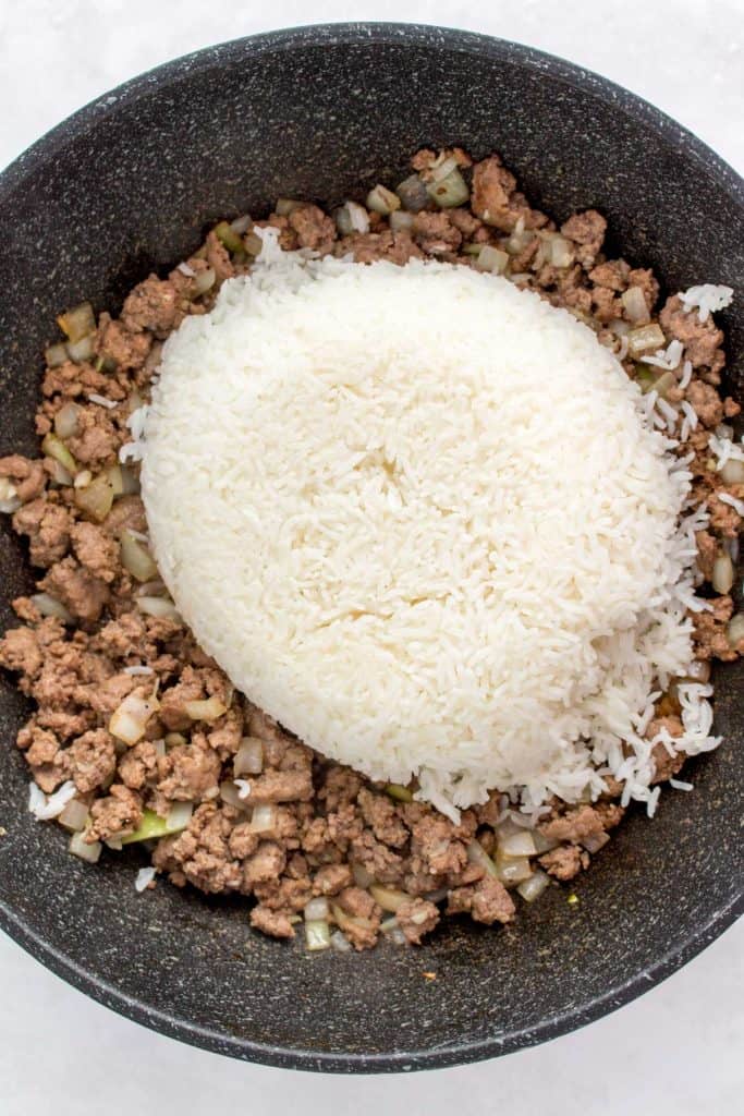 Combing the beef with rice to make beef riced rice.