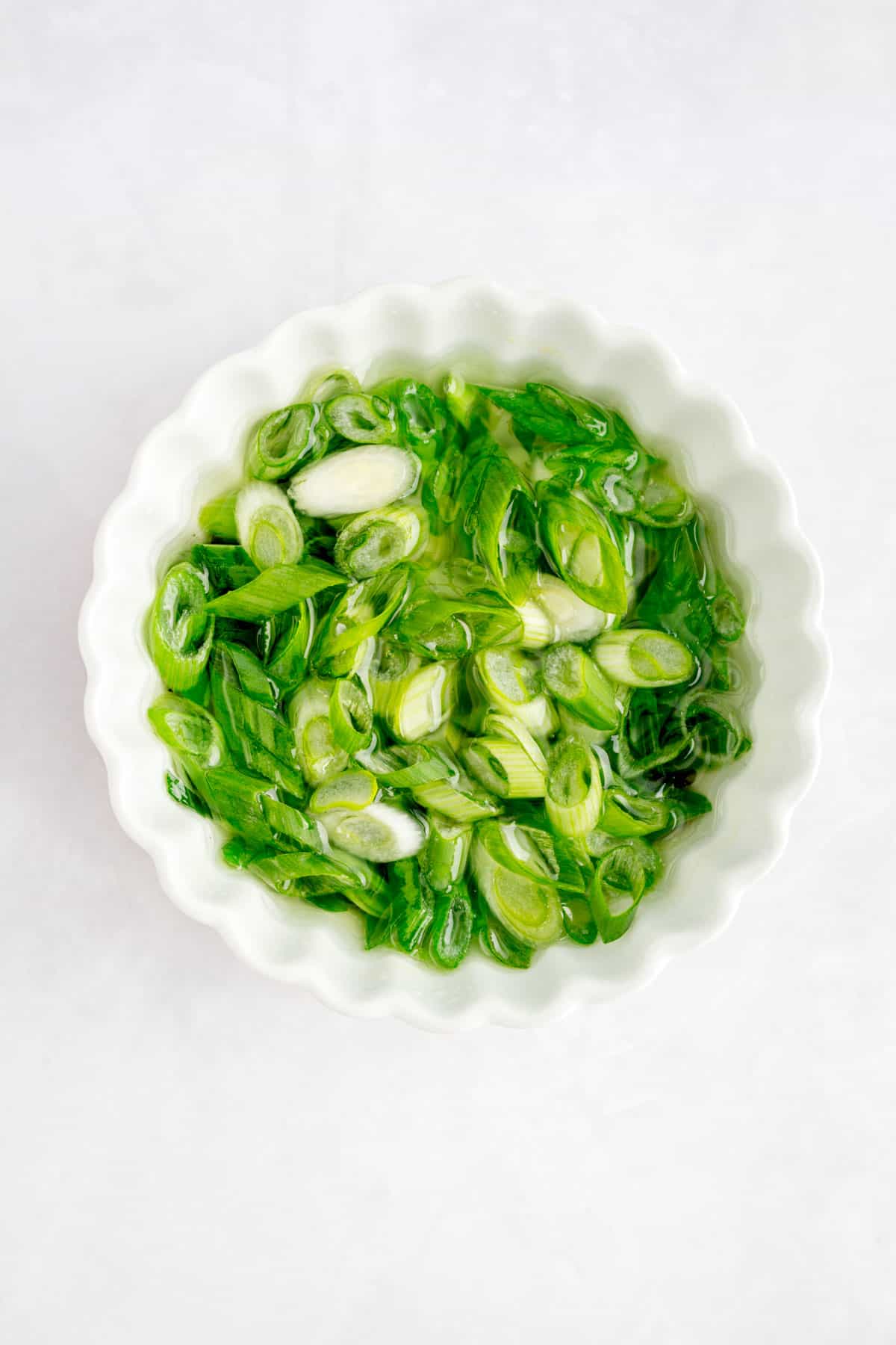 Close up of scallion oil in a small plate.