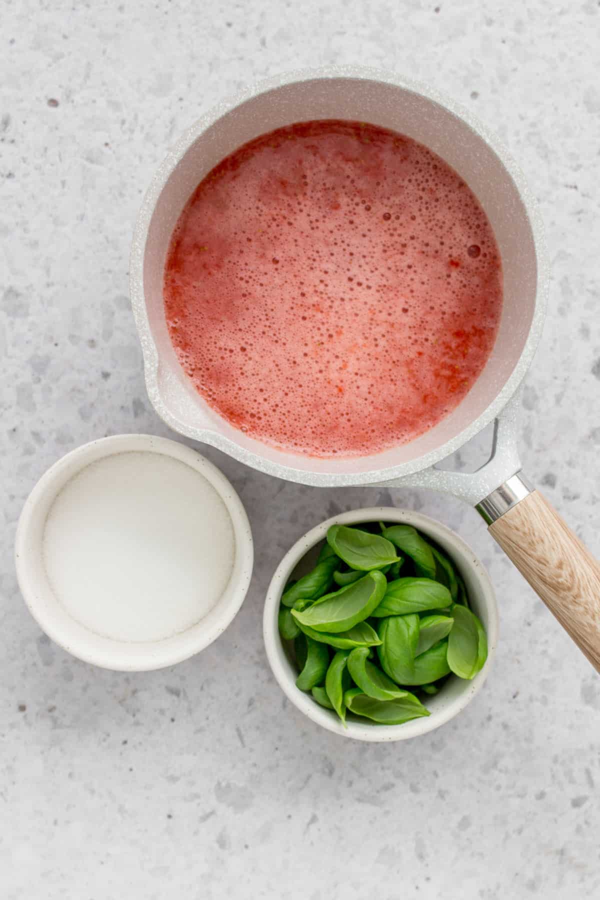Pureed strawberry with sugar and basil beside it.