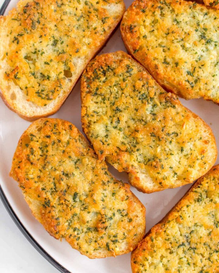Close up of garlic bread on a plate.