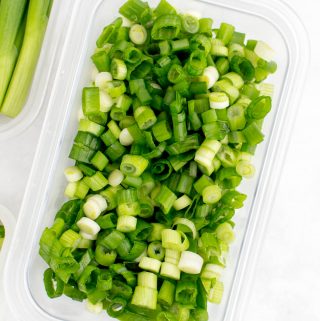 Sliced green onions in a container.