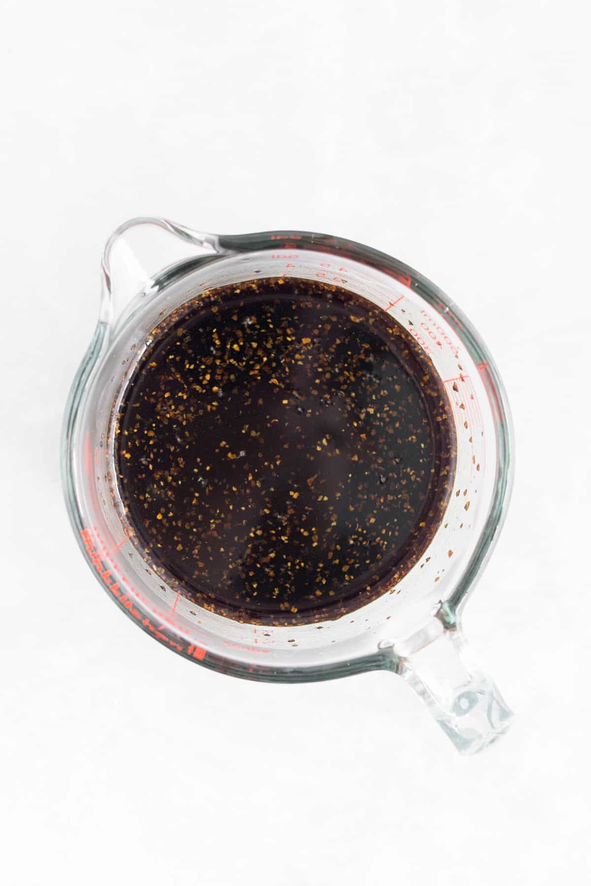 Black pepper sauce in a measuring cup.