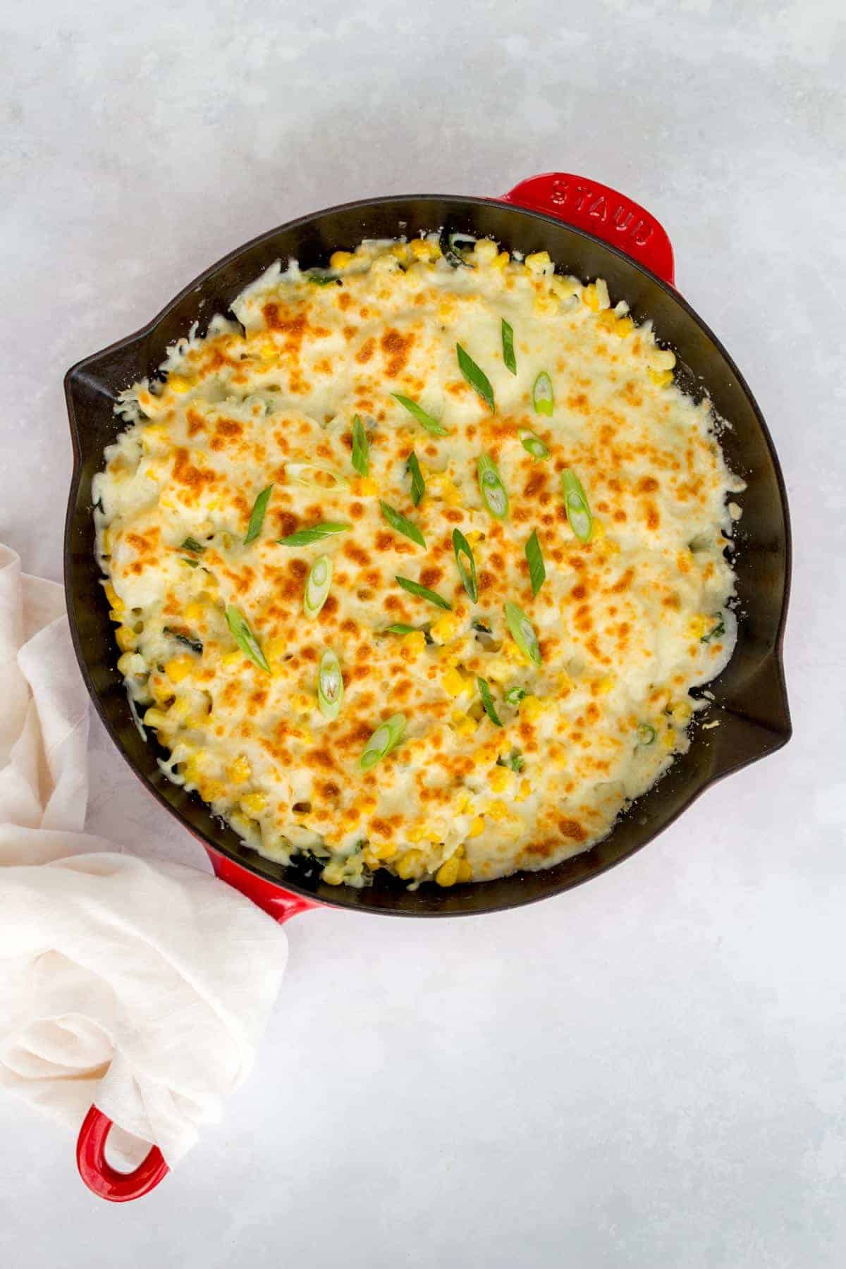 A red Staub cast iron with Korean cheese corn.